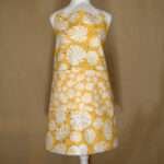 monster-ah design apron in orange on mannequin from hem and tassel