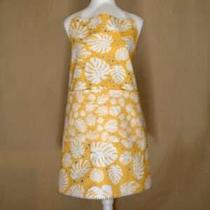 monster-ah design apron in orange on mannequin from hem and tassel