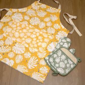 monster-ah design apron in orange with turf oven mitt and pot holder flat from hem and tassel