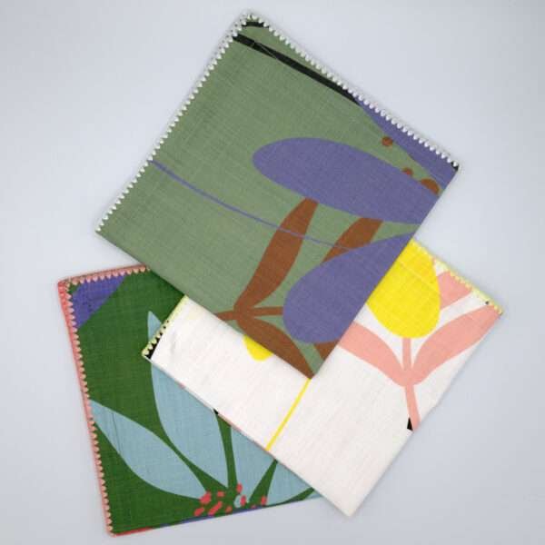 pollen up design three dinner napkins fanned from hem and tassel