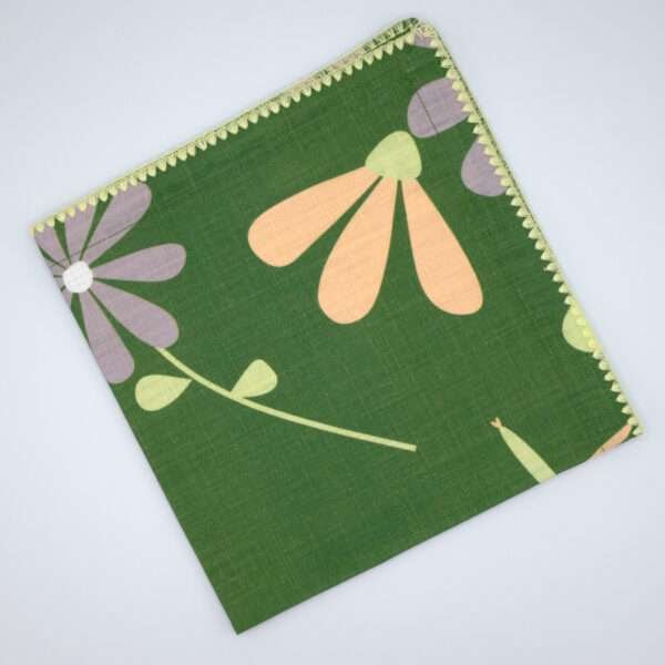 shy dragonfly design dinner napkin in green flat folded from hem and tassel