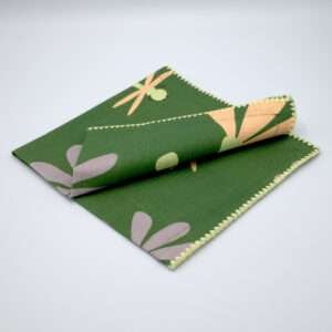 hiding shy dragonfly design dinner napkin in green folded from hem and tassel