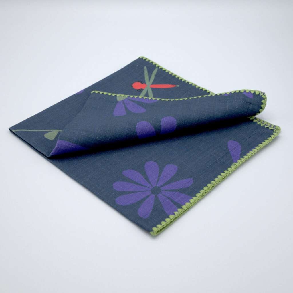shy dragonfly hiding among flowers. Design dinner napkin in oil folded from hem and tassel