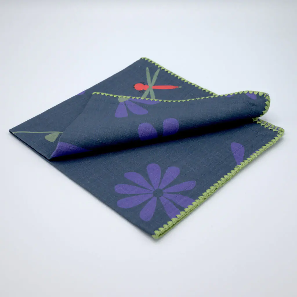 shy dragonfly hiding among flowers. Design dinner napkin in oil folded from hem and tassel