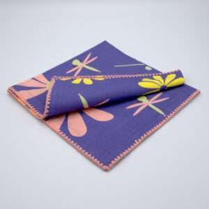 hiding shy dragonfly design dinner napkin in purple folded from hem and tassel