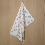 shy dragonfly flowers design hanging tea towel in buff annd grey from hem and tassel