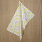 shy dragonfly design hanging tea towel in yellow blush from hem and tassel
