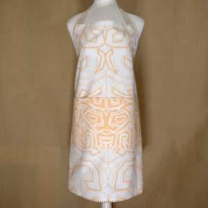 squiggles symmetric design apron in buff on mannequin from hem and tassel