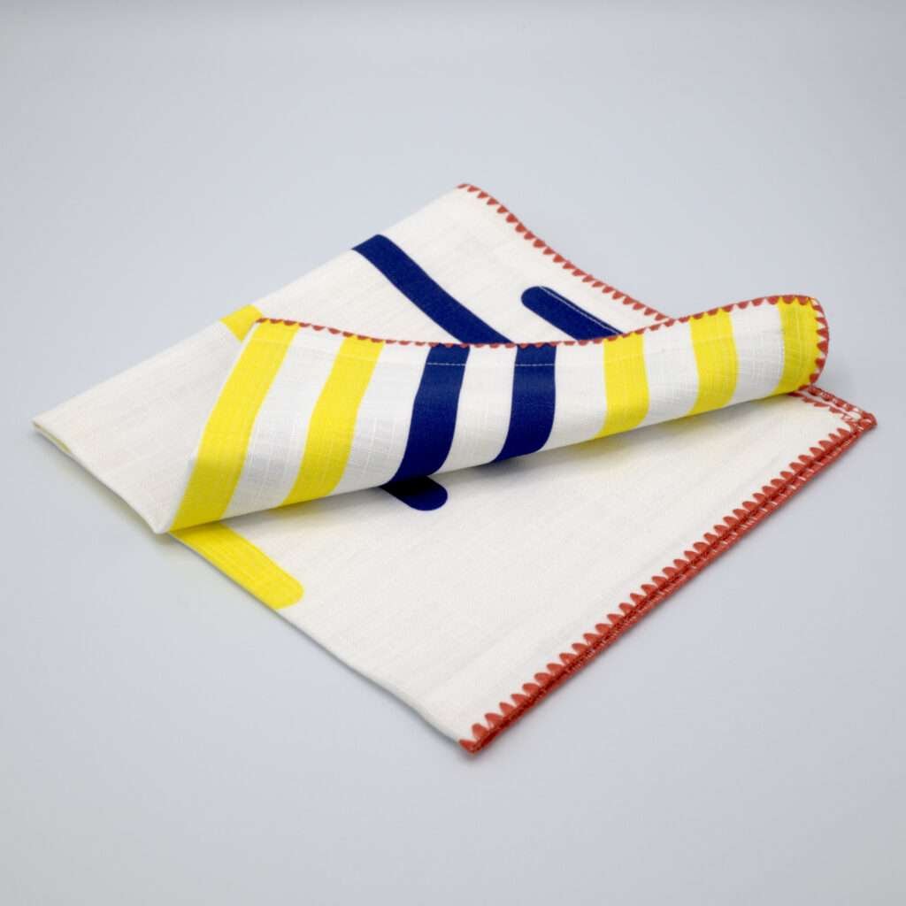 yellow piano design dinner napkin folded from hem and tassel