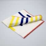 yellow piano design dinner napkin folded from hem and tassel