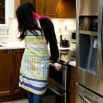 Apron of Not straight Buff design on woman in kitchen by Hem and Tassel