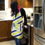 Apron of Yellow Piano design on woman in kitchen by Hem and Tassel