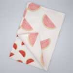 Faded melon design tea towel flat folded from hem and tassel