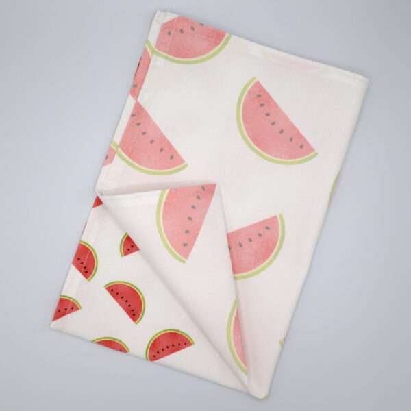 Faded melon design tea towel flat folded from hem and tassel