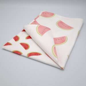 Faded melon design tea towel folded from hem and tassel