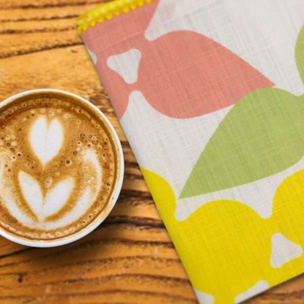 celebration design dinner napkin with cup of designer coffee on table from hem and tassel