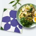 celebration dinner napkin in purple with a meal plate from hem and tassel