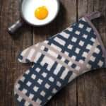 Jute Impossible oven Mitt in Slate with a skillet and fried egg from hem and tassel