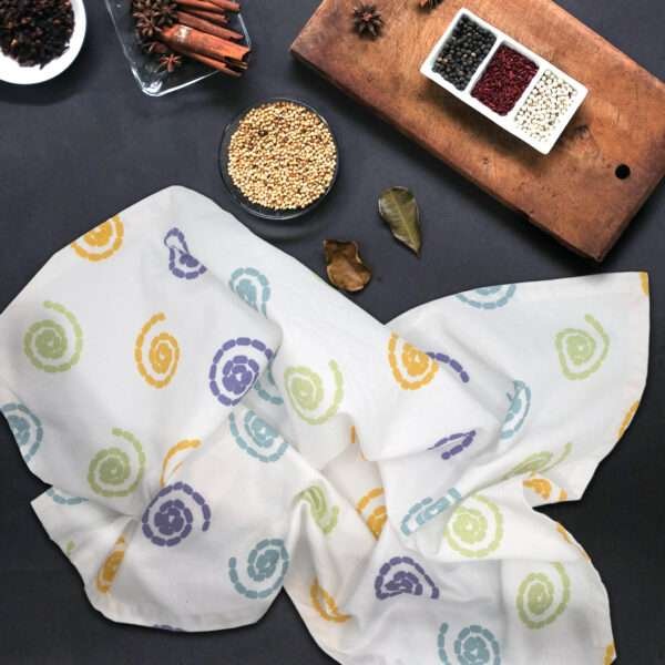 Magic towel on counter with spices from hem and tassel
