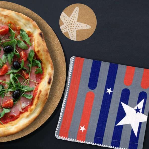 stars and stripes dinner napkin on dining table with pizza and cork coaster of starfish motif