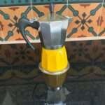 Yellow induction moka pot image by customer shown sitting on high-end induction stove top