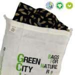 Large Green City Life produce bag as garment wash bag with delicate shirt insidefrom hem and tassel
