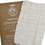 one pack of organic cotton Cheesecloth and cheesecloth fabric shown unpackedfrom hem and tassel